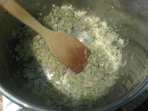 Softening the chopped onion in the fat from browning the meat